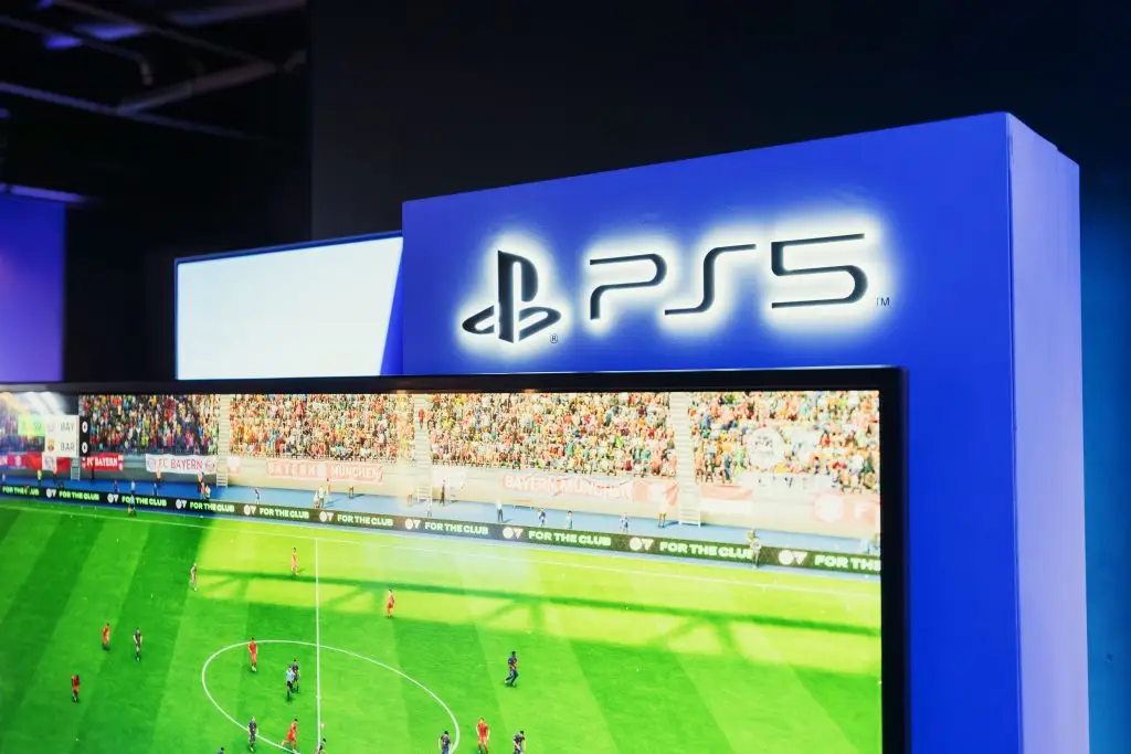 PS5 gaming station featuring a live soccer match onscreen, showcasing high-quality graphics.